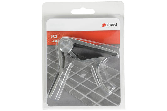 Guitar capo in packaging with Chord brand label on a white background