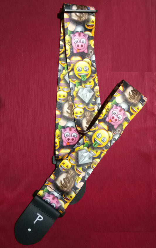 Colorful emoji-patterned guitar strap on a red background