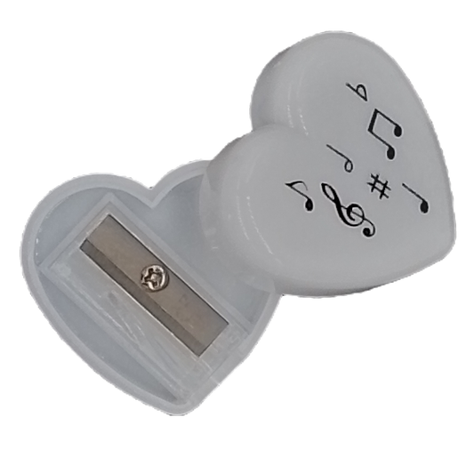 Heart-shaped sharpener with musical symbol designs on a white background