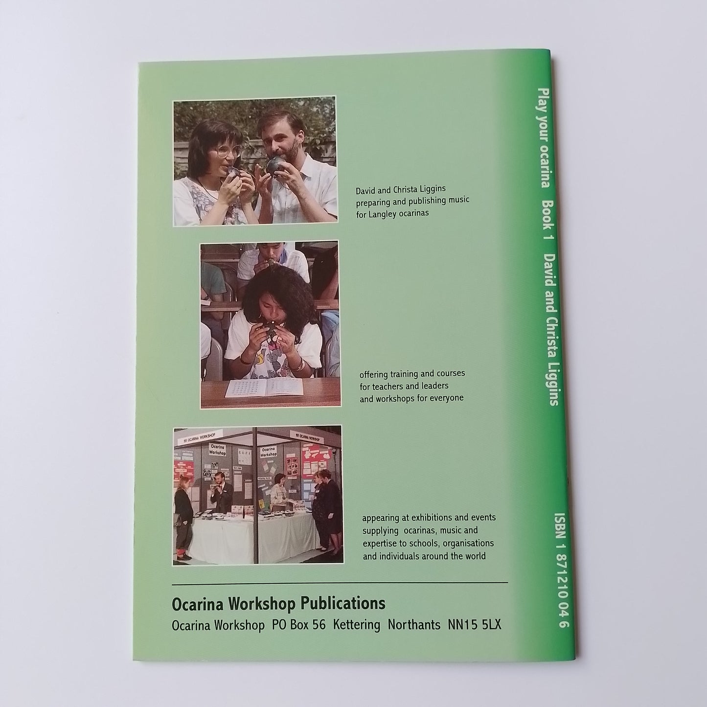 A green printed booklet or publication cover titled 'Play your ocarina Book 1 David and Christa Liggins' with ISBN text at the top and three small inset photos along the lower middle section, photographed on a light neutral background.