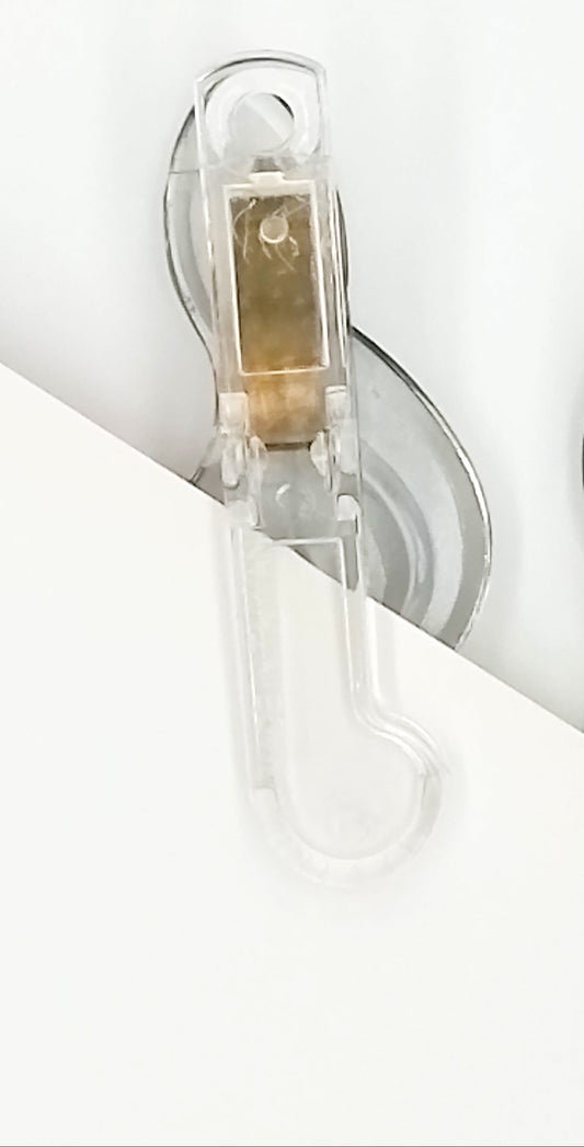 Close-up of two clear plastic paper clips