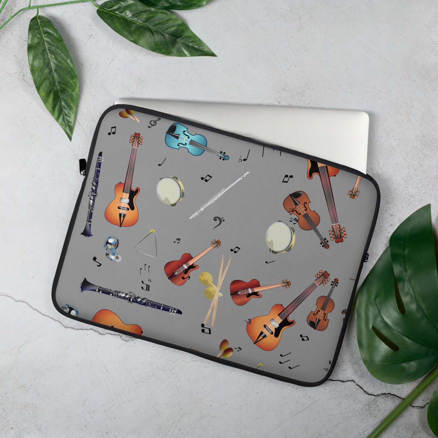 Gray laptop case with musical instrument design on a white background