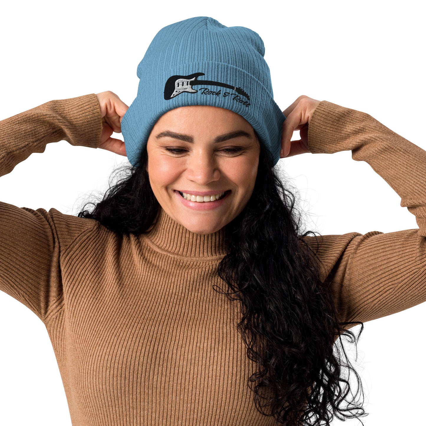 Woman wearing a blue beanie with text, smiling against a white background