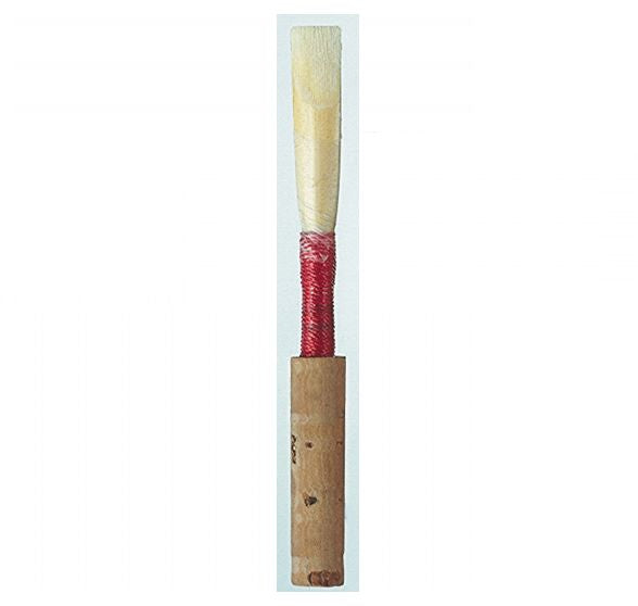 Wooden reed with red wrap and cork a white background