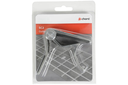 Guitar capo in packaging with Chord brand label on a white background
