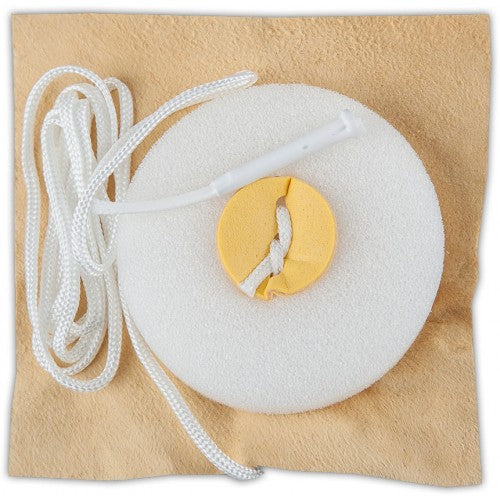 This is a layered pull through : A  yellow cloth with  a white circular sponge with in the middle. A rope binds the various materials together to pull them all together through the instrument. 