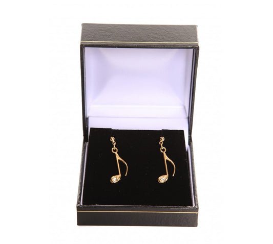 Gold plated note-shaped earrings in a black jewellery box with a white interior