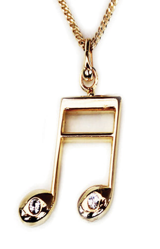 Gold plated music note pendant necklace on a white background