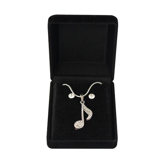 Jewelry set with a studded music note pendant and matching earrings in a black box.