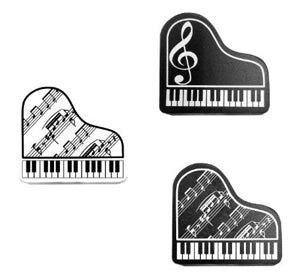 Three black and white piano-themed eraser on a white background