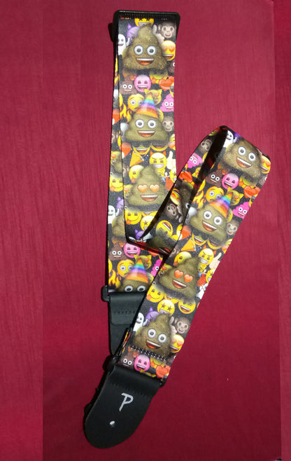 Multicolored emoji-patterned guitar strap on a red background