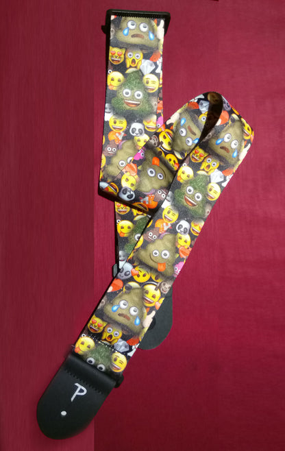 Guitar strap with emoji pattern on a red background