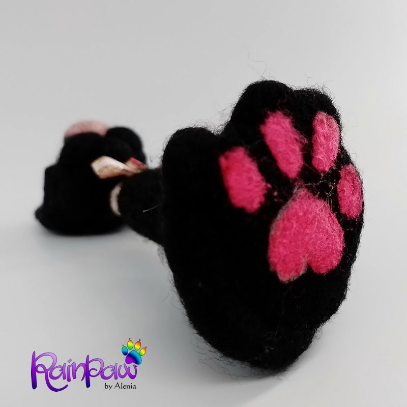 Black cat with pink paw on the bottom of the figurine. The image features the brand 'Rainbow by Alenia'.