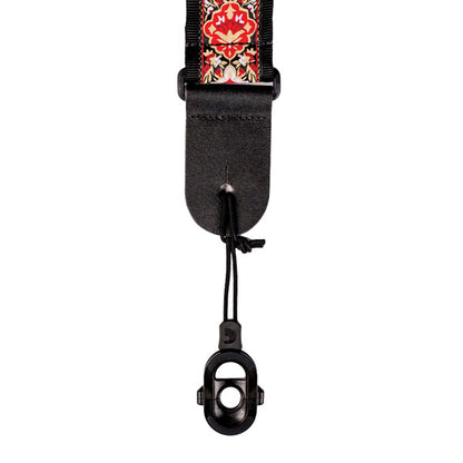 The black device is attached to one extremity of the trap instead of been attached to the guitar pin.