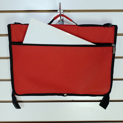 A red and black zippered document pouch hanging from a metal hook on a white slatwall. A white folder is partially tucked into the front pocket.