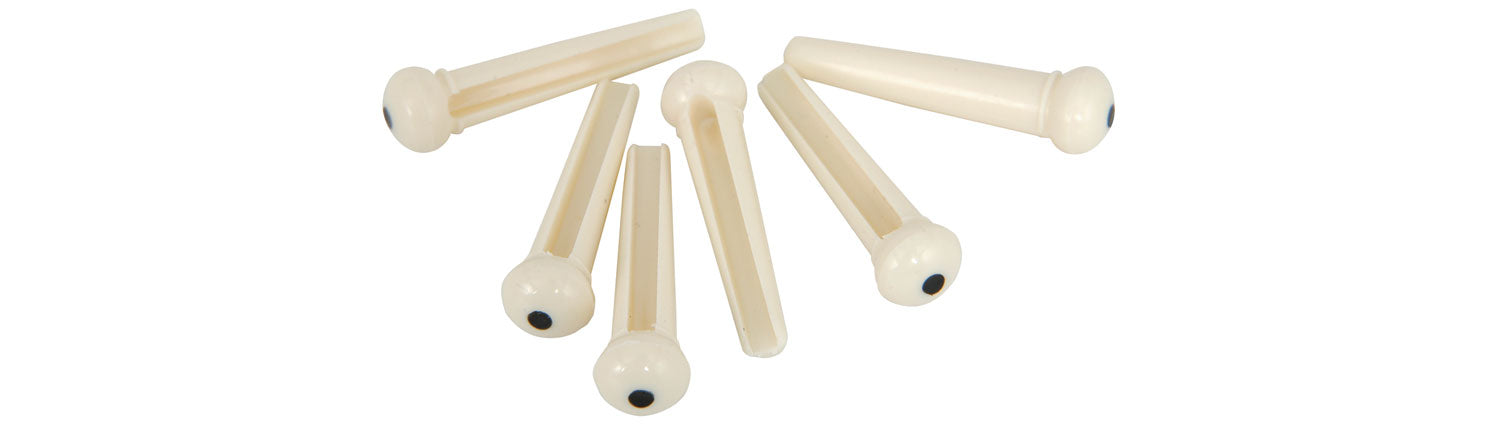 Set of acoustic guitar bridge pins on a white background