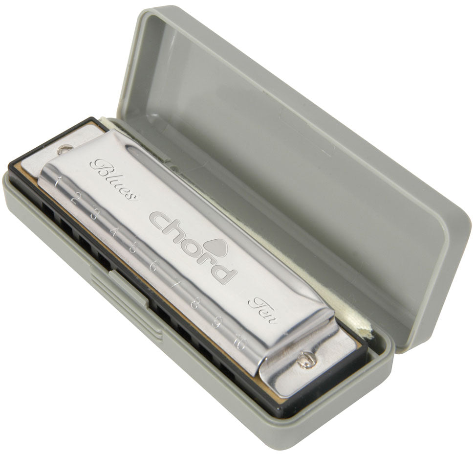 Chord harmonica in a gray case on a white background