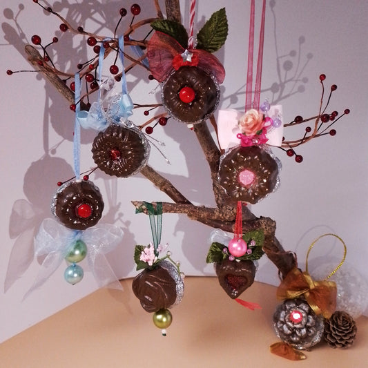 Decorative tree with chocolate ornaments on a plain background