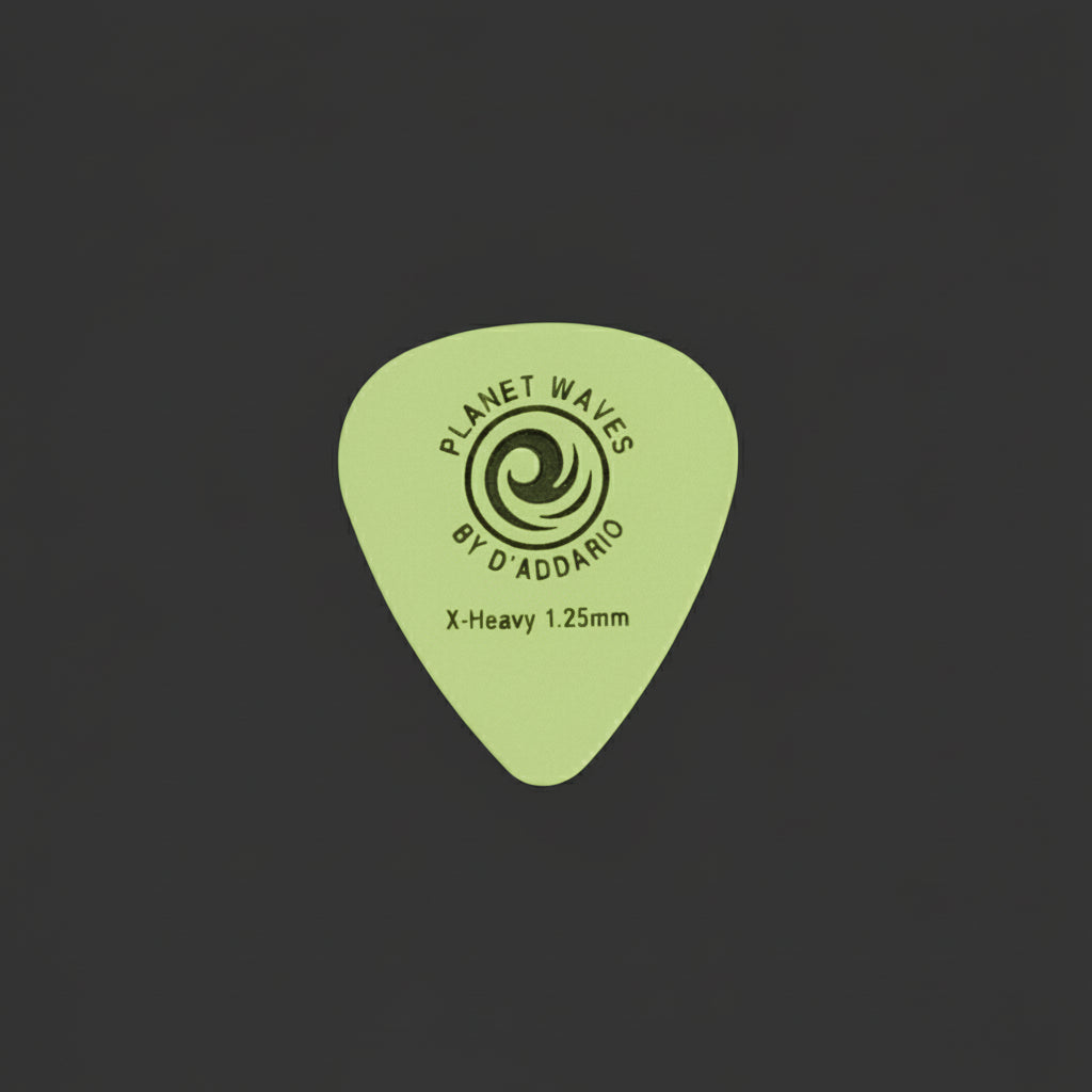 A single off-white plastic guitar pick with black printed text and a swirl logo, reading 'Planet Waves' and 'Omen by D'Addio', placed on a textured gray surface.