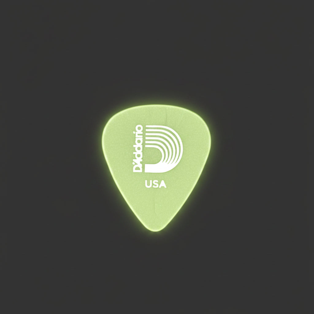 A single D'Addario guitar pick with a white logo and 'USA' text, displayed on a textured dark gray background.
