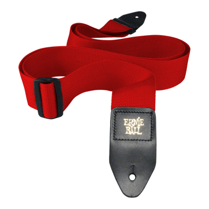 Red guitar strap with black buckle and Ernie Ball logo on a black background