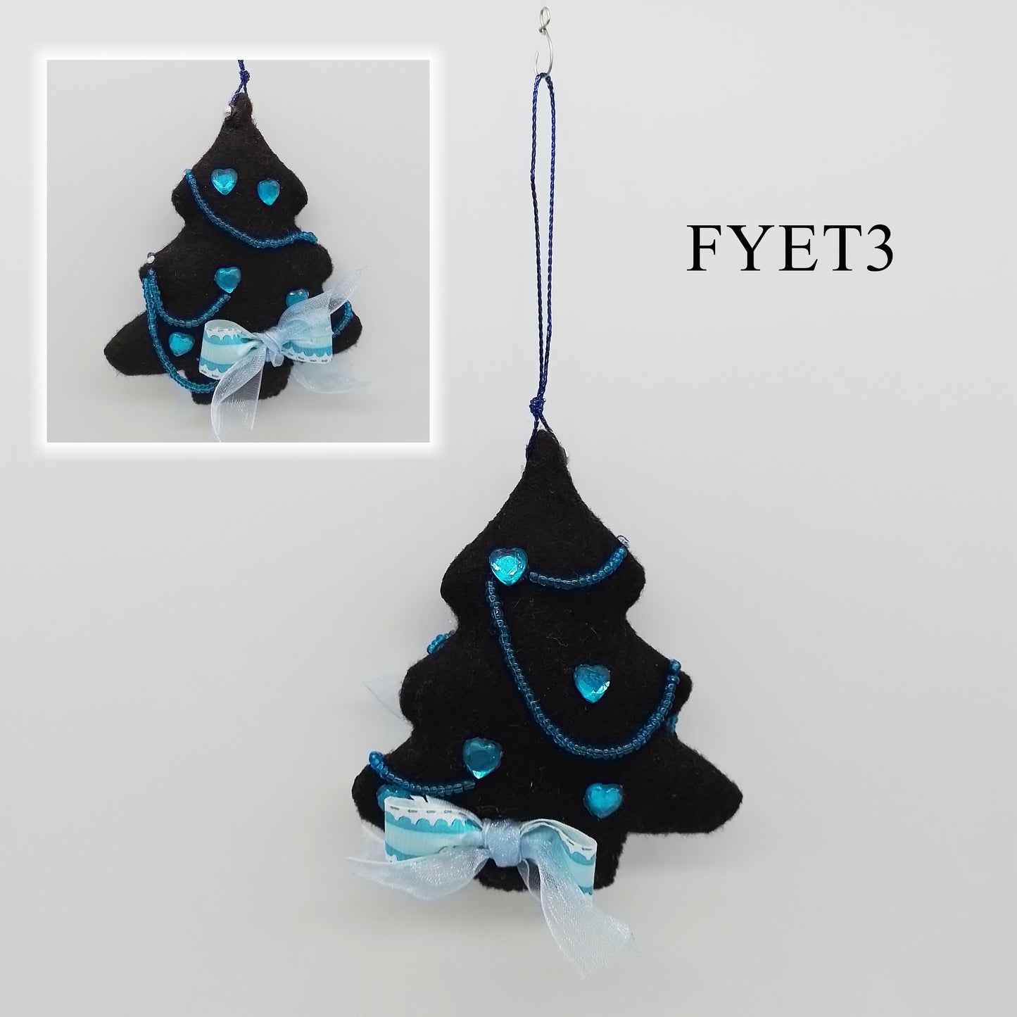 A black felt tree, decorated with shiny light blue hearts, accented with strings of beads and finished with a decorative bow.