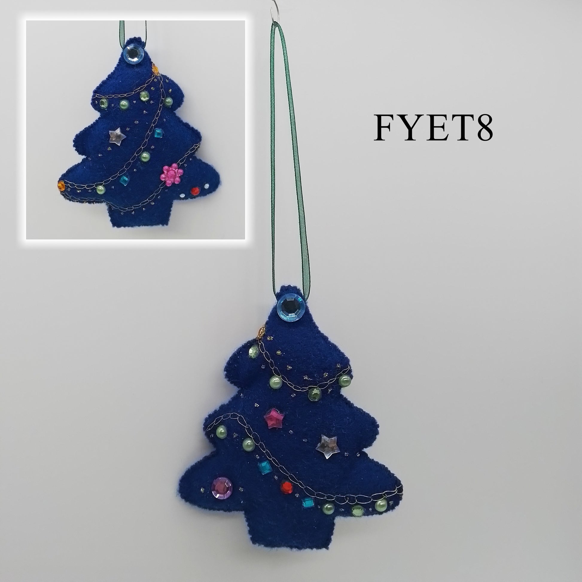 A beautiful blue felt Christmas tree ornament features an embroidered chain stitch and colourful beads and rhinestones.
A delicate blue ribbon serves as the hanger.