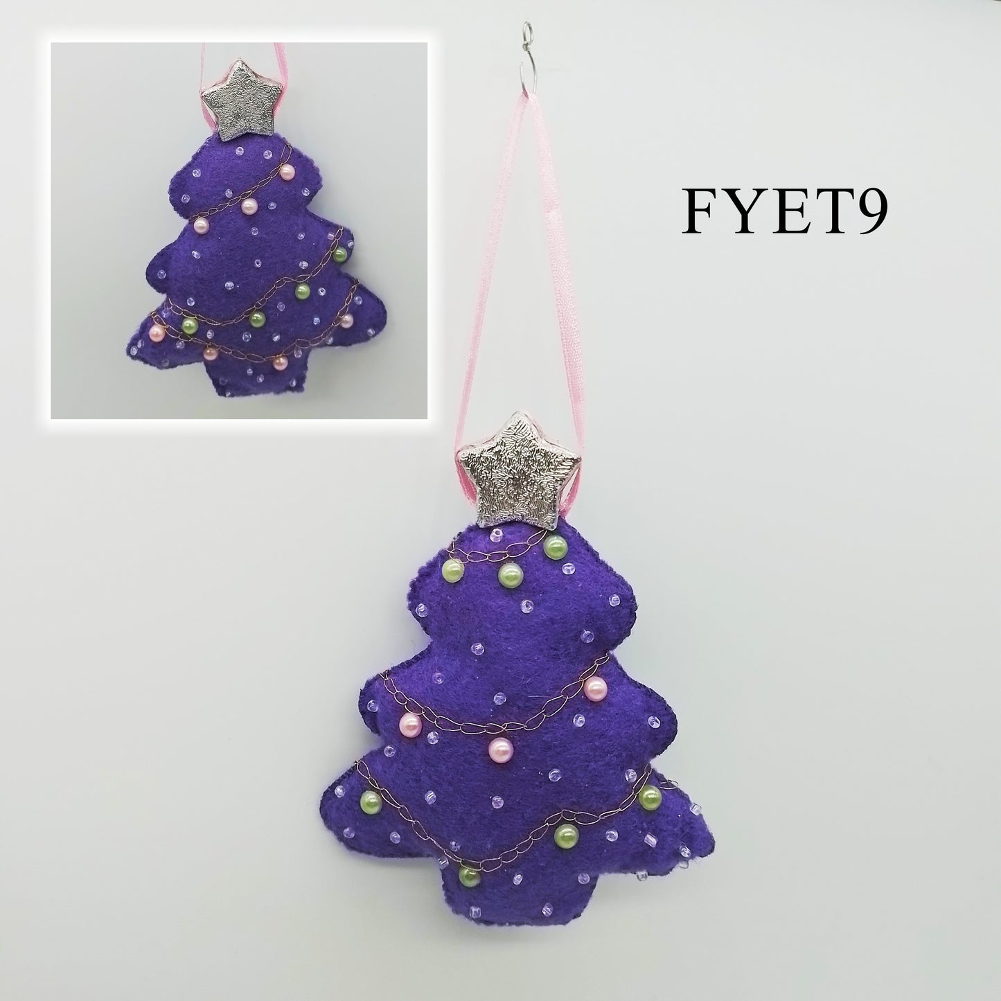 A one-of-a-kind purple felt Christmas decoration features an embroidered chain stitch detail, along with the pearl-pink, pearl-green and translucent beads. A shimmering silver star adds a dash of magic and wonder, while a delicate pink ribbon serves as a lovely hanger.