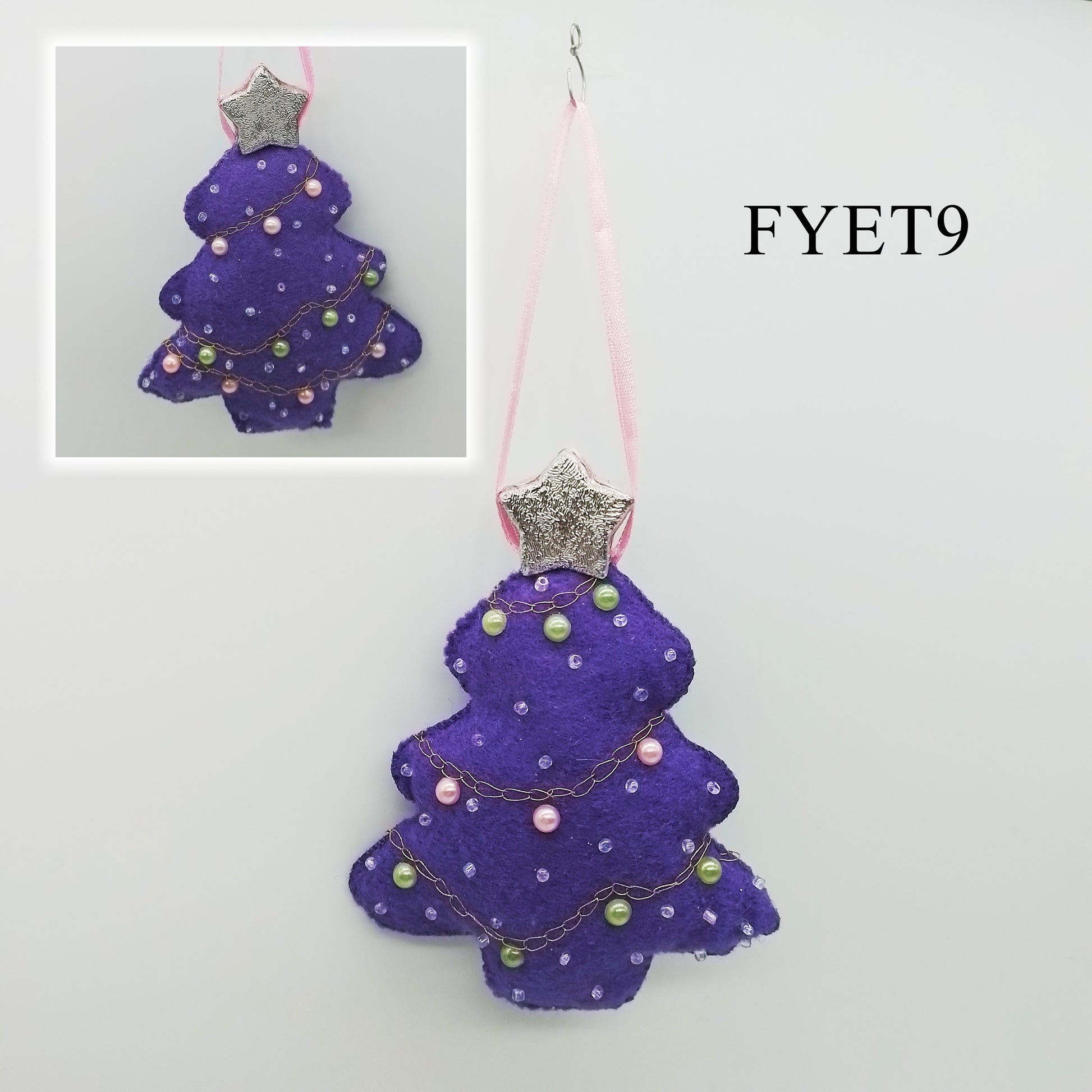 A one-of-a-kind purple felt Christmas decoration features an embroidered chain stitch detail, along with the pearl-pink, pearl-green and translucent beads. A shimmering silver star adds a dash of magic and wonder, while a delicate pink ribbon serves as a lovely hanger.