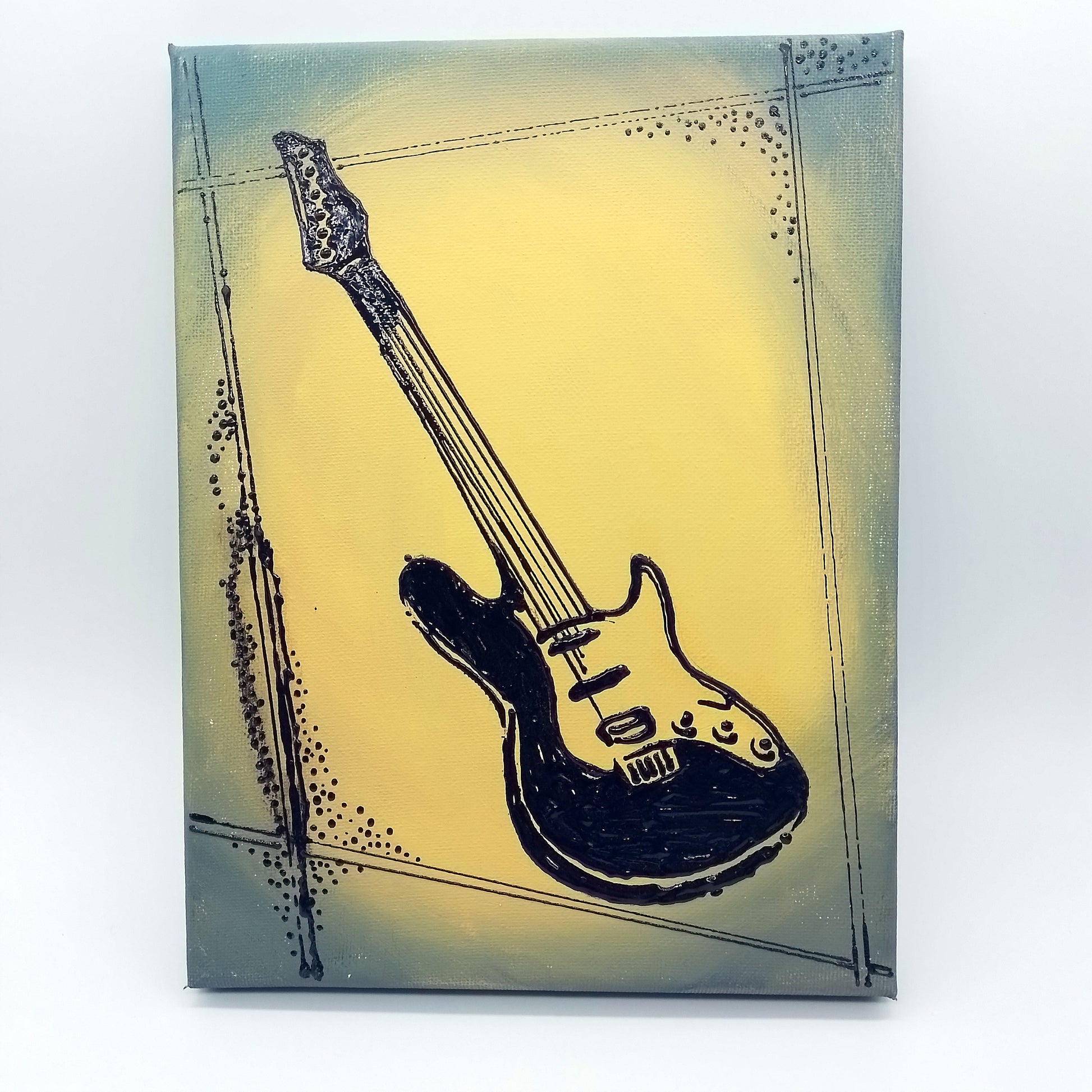 Black electric guitar on forest green and yellow background. The shape of the instrument is a light relief on a flat surface.