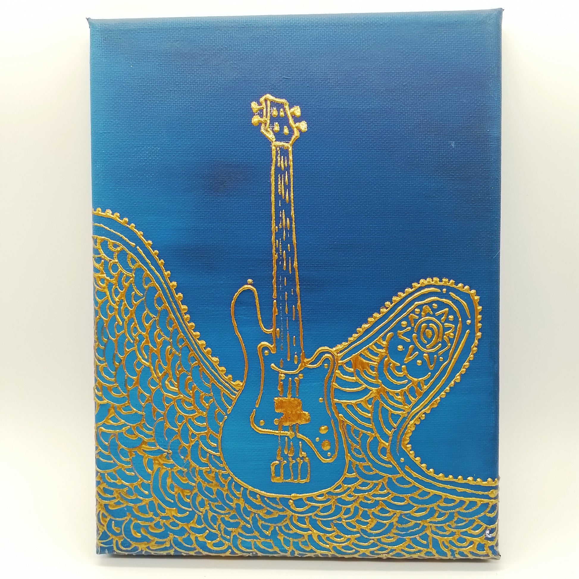 Gold electric bass guitar and decorative elements on blue  background. The shape of the instrument is a light relief on a flat surface.