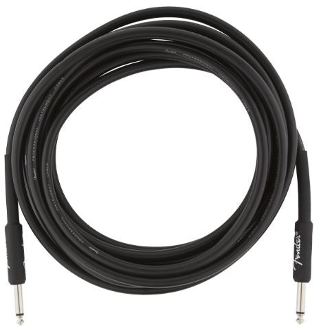 Coiled black guitar cable on a white background