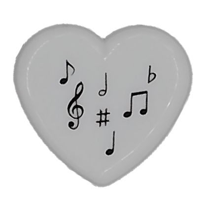 Heart-shaped pencil sharpener with musical symbols on a white background