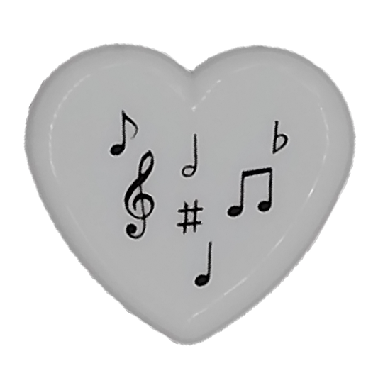 Heart-shaped pencil sharpener with musical symbols on a white background