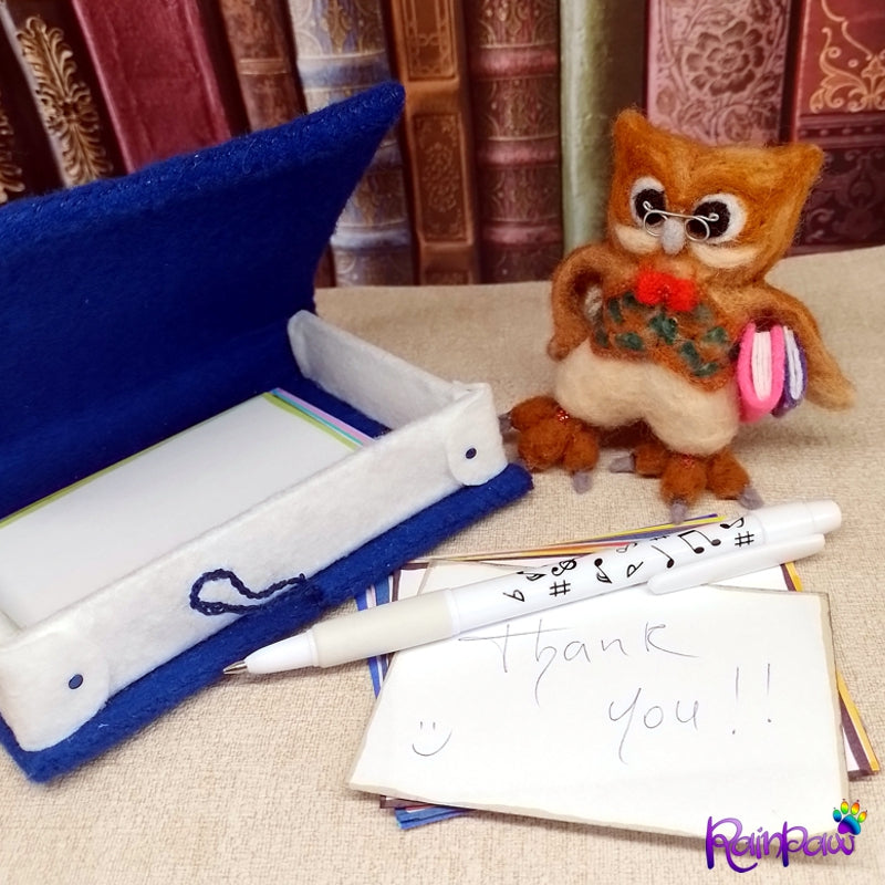 The owl is designed to hold a pen under one wing, while the paper provides a convenient place to jot down your thoughts, the book-shaped box a place to store store them.