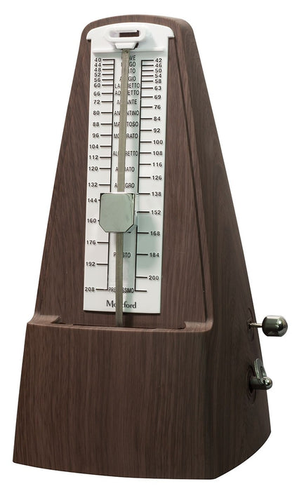 Plastic, wooden effect metronome with a clear face displaying numbers on a white background