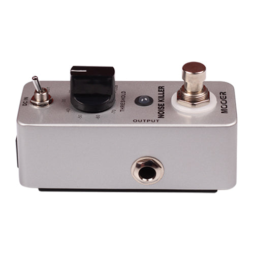 Guitar effects pedal with knobs and switches on a white background