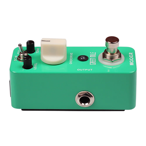 Green guitar effects pedal with various controls on a white background