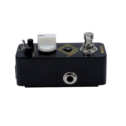 Guitar effects pedal with knobs and switch on a white background