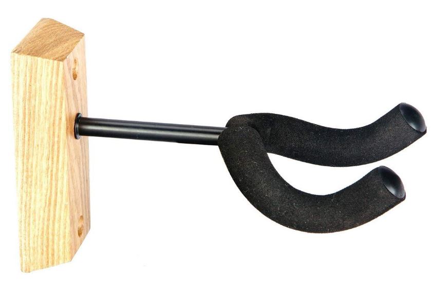 Black guitar capo attached to a wooden block on a white background