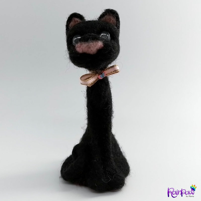 Black cat-shaped figurine with a bow tie on a white background