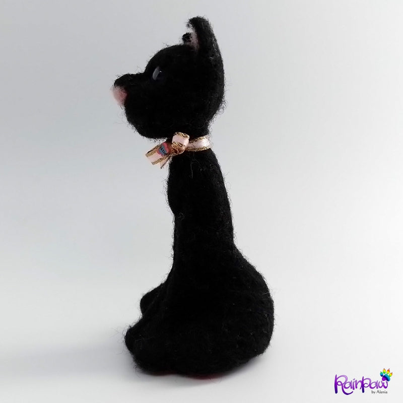 Black cat with a pink bow on a white background