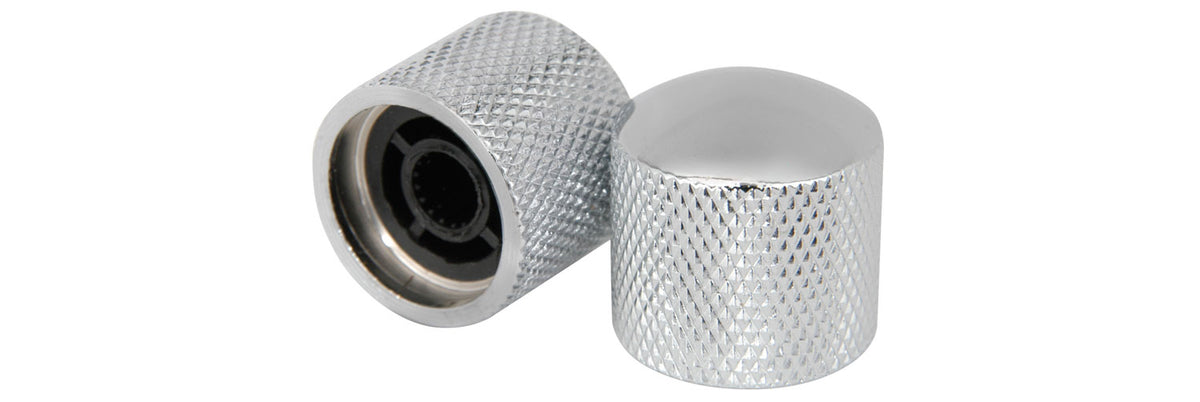 Two metallic knobs with textured surfaces on a white background