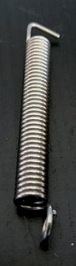 Metal spring with curved ends on a black background