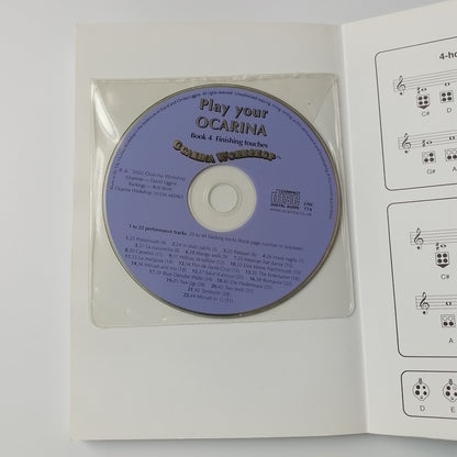 A lavender-purple CD in a clear plastic sleeve, placed inside an open white booklet with printed musical notation diagram.