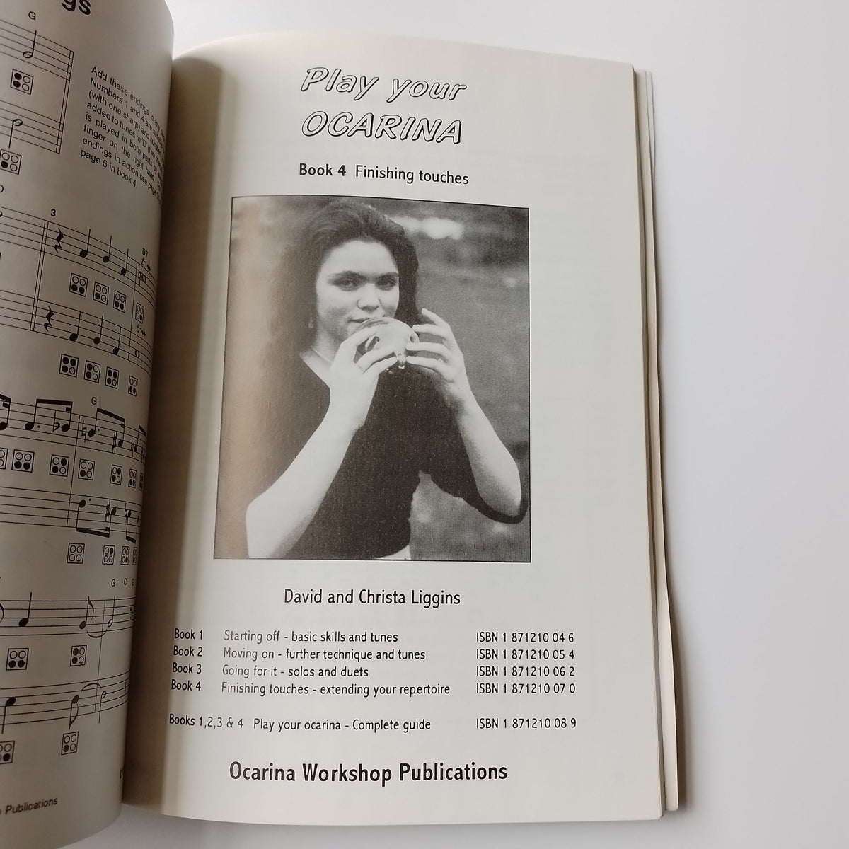 An open sheet music book showing the cover page for 'Play Your Ocarina Book 4' by David and Chrisa Loggins, with a black-and-white photo of a woman playing an ocarina. The page includes publication text and a second open page below with musical notation.