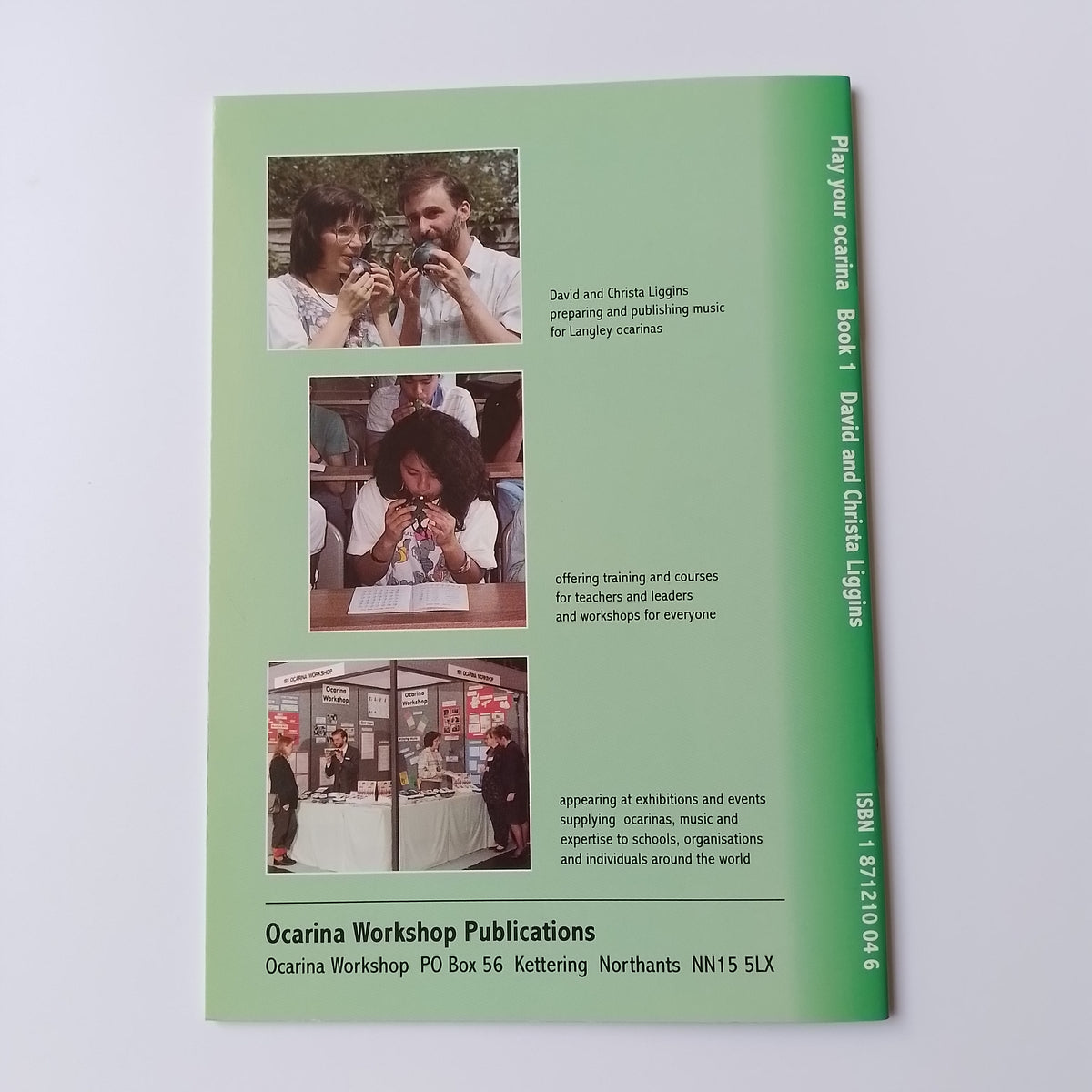 A green printed booklet or publication cover titled 'Play your ocarina Book 1 David and Christa Liggins' with ISBN text at the top and three small inset photos along the lower middle section, photographed on a light neutral background.