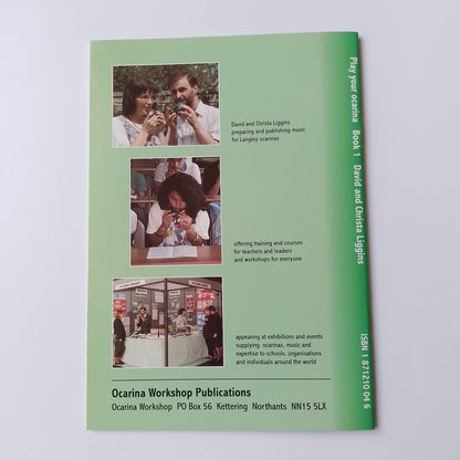 A green printed booklet or publication cover titled 'Play your ocarina Book 1 David and Christa Liggins' with ISBN text at the top and three small inset photos along the lower middle section, photographed on a light neutral background.