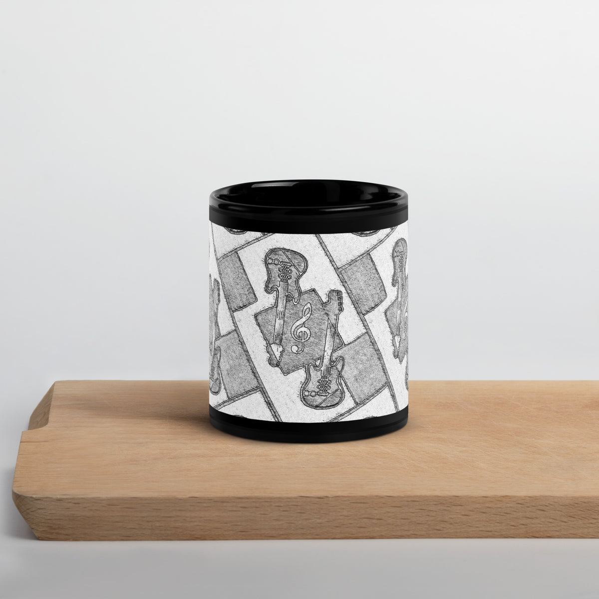 A mug featuring a mosaic-like geometric shaped design on a wooden surface with a light grey background.