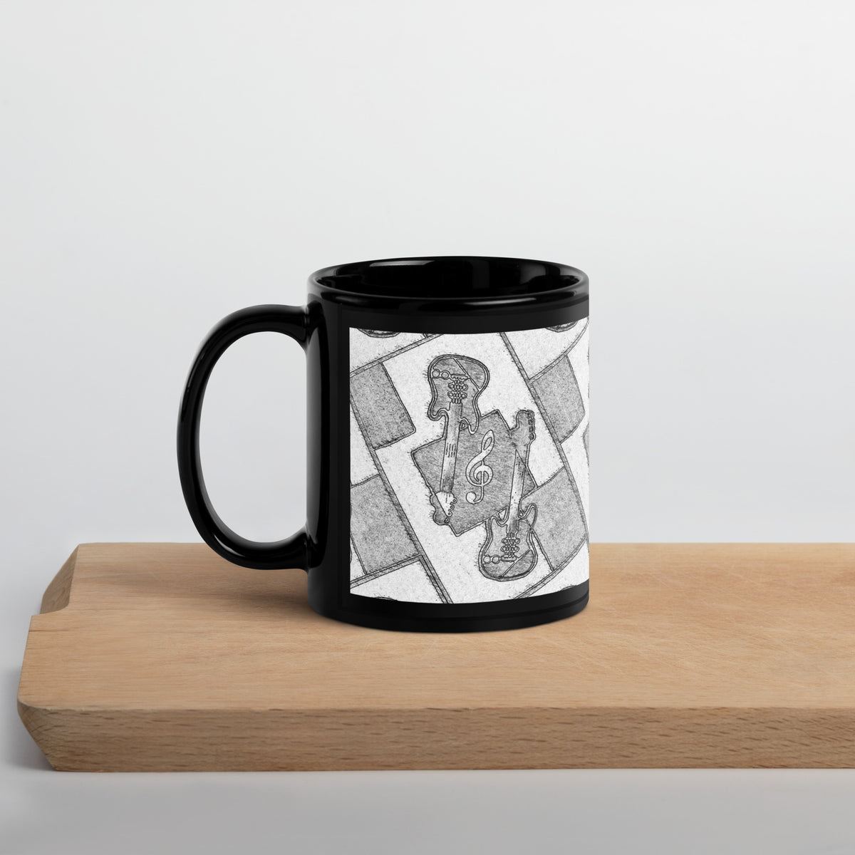 Black mug with a white design on a wooden surface